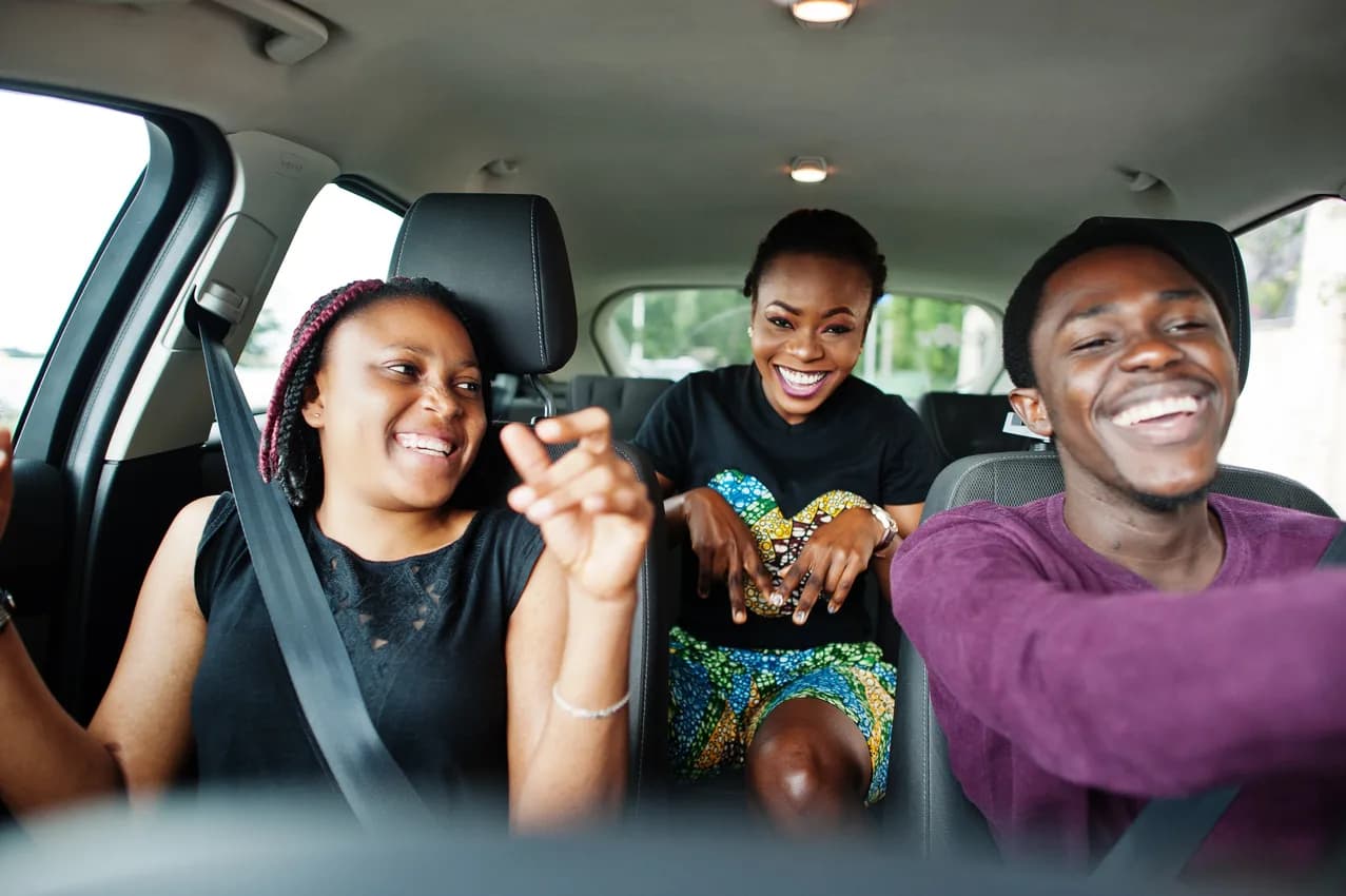A family laughing together in a car on a journey