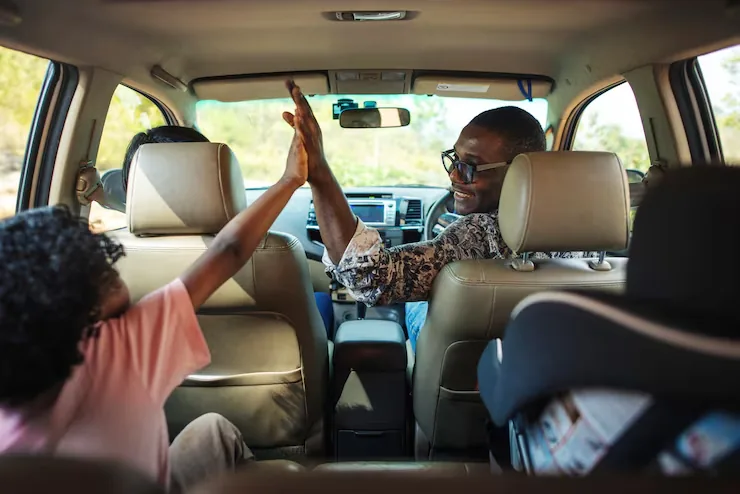 Passengers celebrating with a high five next to an OCI vehicle